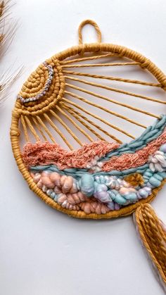 a close up of a woven object on a white surface with other items in the background