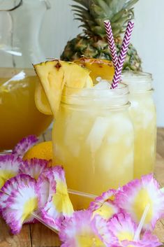 two mason jars filled with pineapple punch