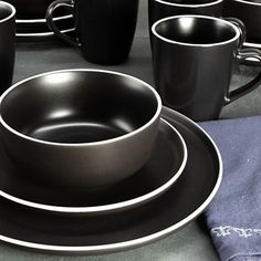 black and white dinnerware set on top of a table