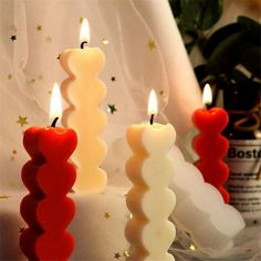 three candles that are sitting next to each other