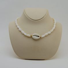 This beautiful choker is hand made with Cowrie seashell, mother of pearl beads cowrie sea shell choker necklace, natural shell All my jewelery is hand crafted with pure and 925 sterling silver , this is a safe way for you to store necklace will be sent along with a beautiful gift box and pouch White Beaded Choker For Vacation, Beaded Shell Choker Necklace, White Round Beads Choker For Beach, Adjustable White Cowrie Shell Necklace, White Strand Choker As A Gift, Adjustable Beaded Shell Pearl Necklace, Handmade White Shell Necklace, White Shell Strand, White Mother Of Pearl Shell Necklace For Vacation