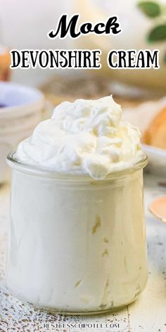 a jar filled with whipped cream sitting on top of a table