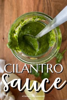 cilantro sauce in a glass jar with a spoon