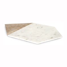 a white marble and wood cutting board on a white background with the edge cut out