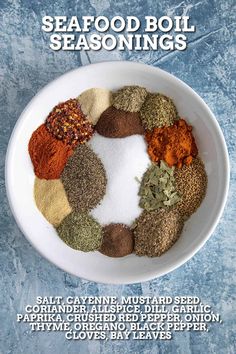 a white bowl filled with different types of seasoning on top of a blue table