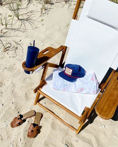 a blue hat is sitting on a beach chair