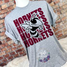 Treat yourself or anyone in your life to this awesome School pride tshirt. It's a hornet thing.  Great for all occasions.  And great for supporting your hornets team.  Shirt is made of 100% polyester and soft to the touch.  To get the best wear from your shirt please  1. Wash with mild detergent  2. Do not use fabric softener  3. Do not use bleach 4. Tumble dry low.  Please enjoy your shirt as I know we have enjoyed all the ones we have made for ourselves!! Please note that every shirt is made to order and normal processing time takes us 5-7 business days to create a shirt and ship out an order; however we strive our very best to get it out sooner!  *some shirts are made by a process called sublimation printing. It is normal if you see some minor fading after your first wash. Items that ar School Sports Shirts, Spirit Wear Shirts, School Tshirt Designs, Cheer Designs, Spirit Wear Designs, School Team Shirts, School Spirit Shirts Designs, Eagles Team, School Shirt Designs