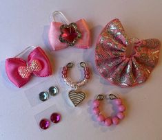 there are many different types of hair accessories on the table, including bows and earrings