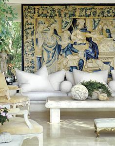 a living room filled with lots of white furniture