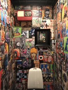 there is a toilet with many pictures on the wall in this bathroom that has been decorated