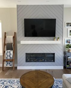 a living room with a tv mounted on the wall above a fire place in front of a fireplace