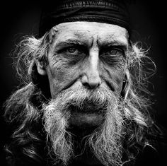 black and white photograph of an old man with long hair