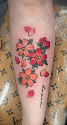 a woman's leg with flowers on it and the word love written in cursive writing