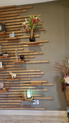 a wall made out of wooden planks with flowers and pictures on the wall next to it