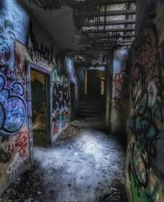 an abandoned building with graffiti all over the walls