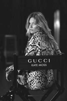 a black and white photo of a woman sitting in a chair with the words gucci on it