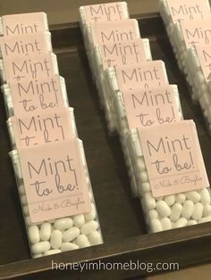 mini to - go bags are lined up on a tray with white chocolates in them