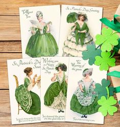 four vintage st patrick's day greeting cards with shamrocks on the wooden table