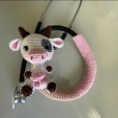 a crocheted cow is attached to a stethoscope