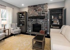 a living room filled with furniture and a fire place