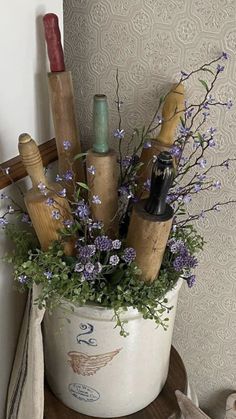 there is a potted plant with flowers in it on the shelf next to a wall