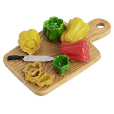 a wooden cutting board topped with bell peppers