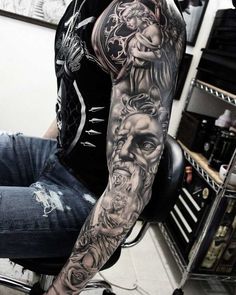 a man with a full sleeve tattoo on his arm