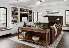 a living room filled with furniture and lots of windows