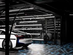 the bmw concept car is parked in an underground parking garage with its doors open and lights on