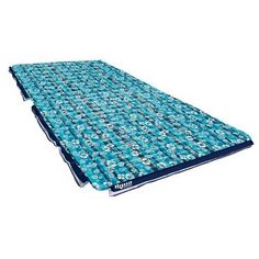 an image of a blue and white sleeping mat with flowers on the bottom, in front of a white background