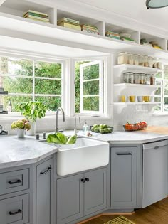 The kitchen redo of this 1940s California bungalow included moving the sink to a new home in an existing bay with all-new windows for front-yard views. Open shelves and storage cubbies keep the space feeling airy and bright. Kitchen Ikea, Farmhouse Cabinets, Kitchen Organizers, House Dream, Casa Country, Family Kitchen, Kitchen Redo, Remodel Bedroom, Kitchen Remodel Idea