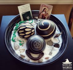 a black plate topped with lots of different types of items on top of a table