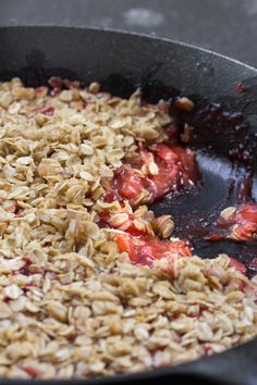 a pan filled with oatmeal and strawberries