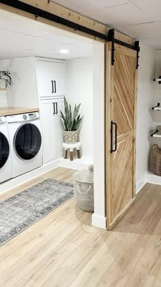 a washer and dryer sitting in a room next to an open closet door