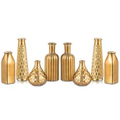 a group of gold vases sitting next to each other