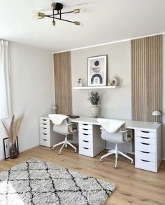 a room with two desks and a rug on the floor in front of it