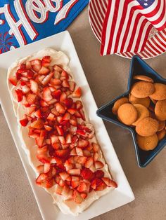 strawberries and cookies on a plate next to a fourth of july flag