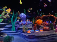 an underwater scene with fish, corals and other marine creatures in the water at night