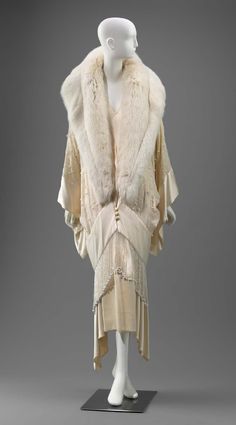 Off-white jacket with large shawl collar of off-white fur (fox?) and center front satin covered buttons with coinciding loops. Kimono style sleeves of silk (crepe) wit … Dress Hat, Kimono Style