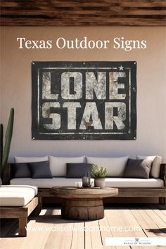 a living room with a couch and coffee table in front of a lone star sign