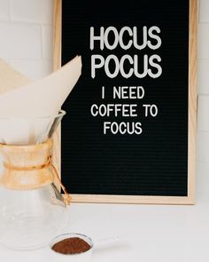 a sign that says hoccus pocus need coffee to focus next to a cup of coffee