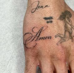 a person's hand with a tattoo on it that says jean and an angel