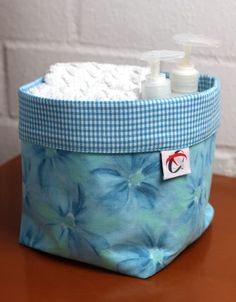 a close up of a bag on a table with soap and lotion in it