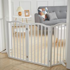 a baby gate in the corner of a living room with a couch and coffee table