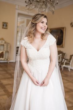 a woman in a wedding dress posing for the camera