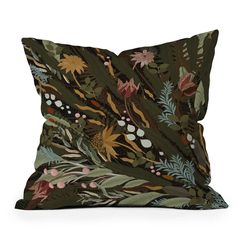 a green pillow with flowers and leaves on it