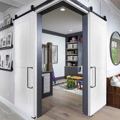 an open door leading into a living room with pictures on the wall