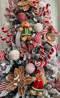 a christmas tree decorated with gingerbread cookies and candy canes