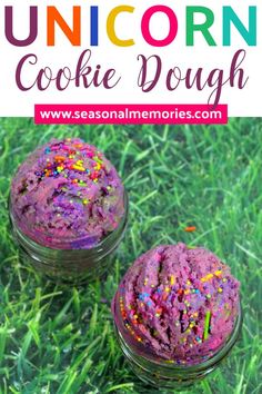 two jars filled with unicorn cookie dough sitting on top of green grass and the words unicorn cookie dough above them