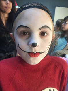 a person with a cat in the hat face paint on their head and wearing a red shirt